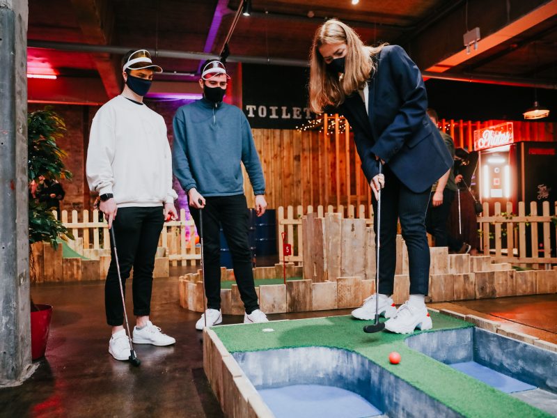 group of people playing crazy golf